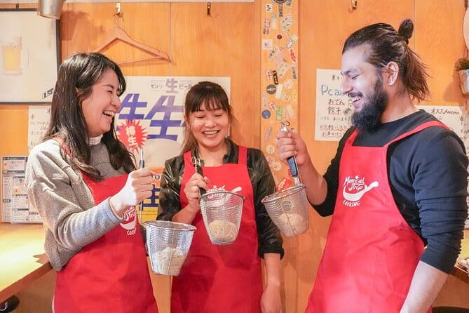 Kyoto Ramen and Gyoza Cooking Class with Professional Chefs - Folding gyoza with a drink in hand