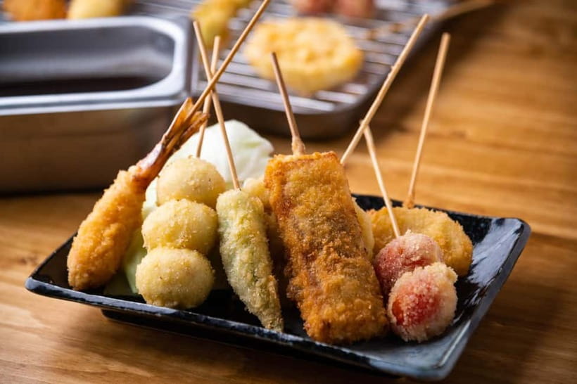 Osaka: Food Tour Kuromon Market & Dotonbori with Guide - Okonomiyaki and kushikatsu near Gigo