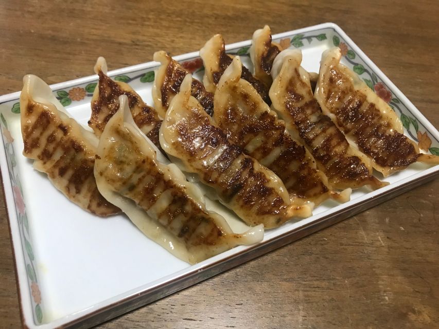 Osaka: Ramen and Gyoza Cooking Class in Dotonbori - Folding chicken gyoza while the dough rests